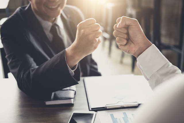 Teamwork of businessman partnership giving fist bump to greeting